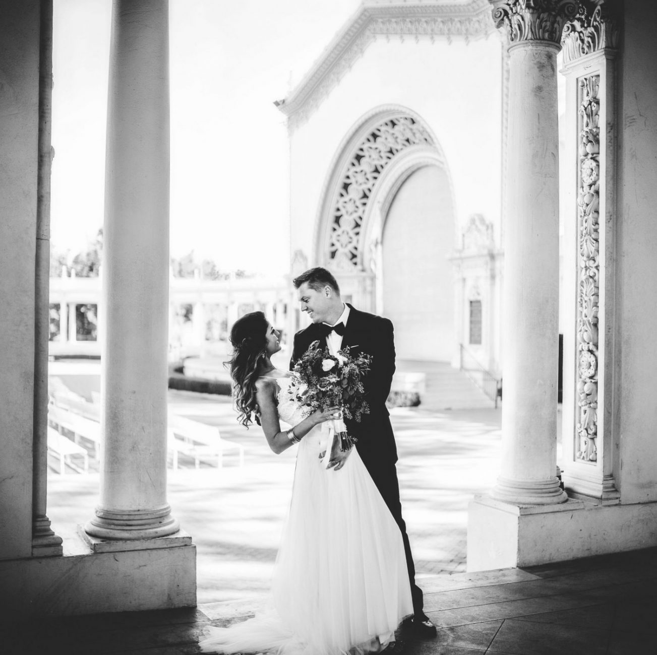a bride and groom standing in an archway